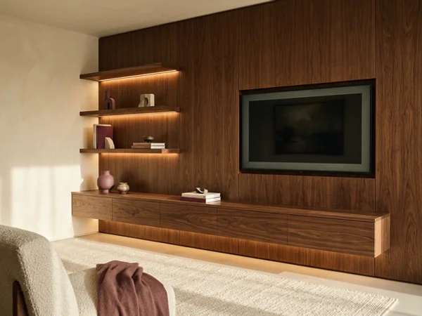 Walnut media wall with LED-lit shelves